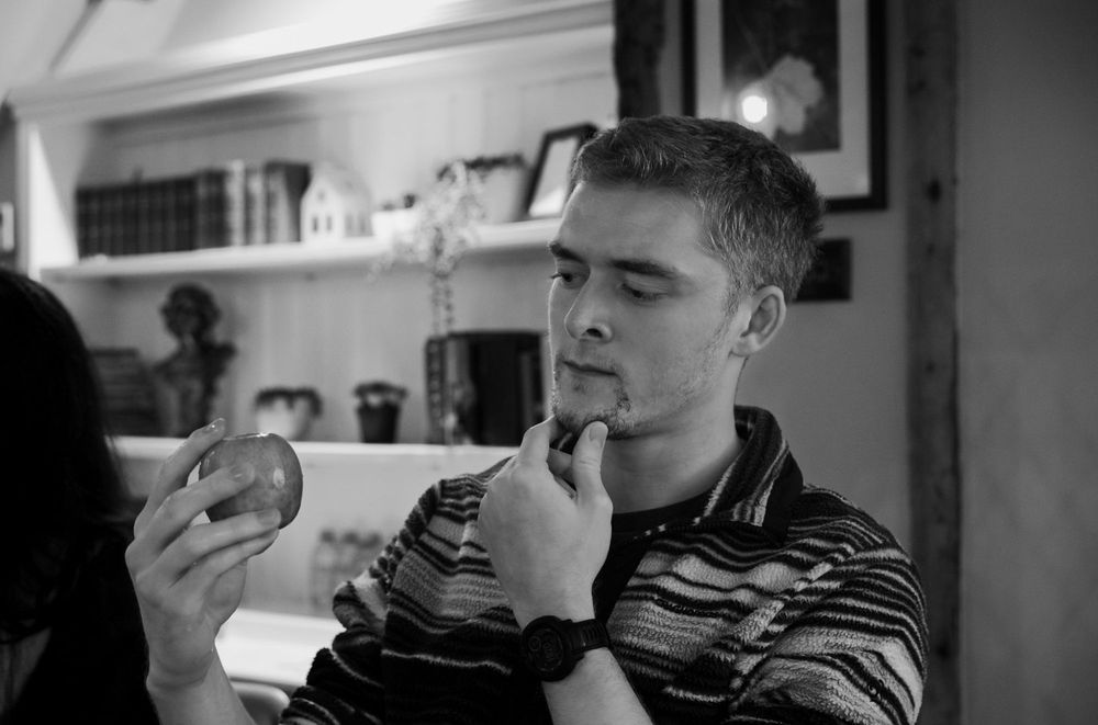 Jamie examining an apple, thinking